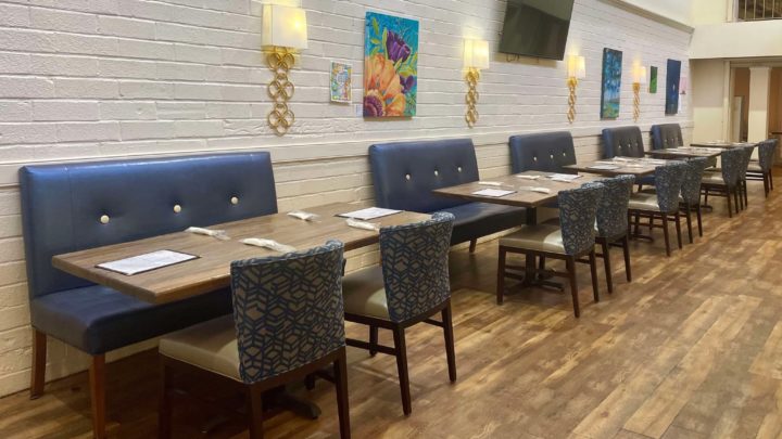 Jenise and Eric Dominguez, new owners of Of Great Taste Bistro, smile inside the newly designed restaurant at Hickory Furniture Mart.